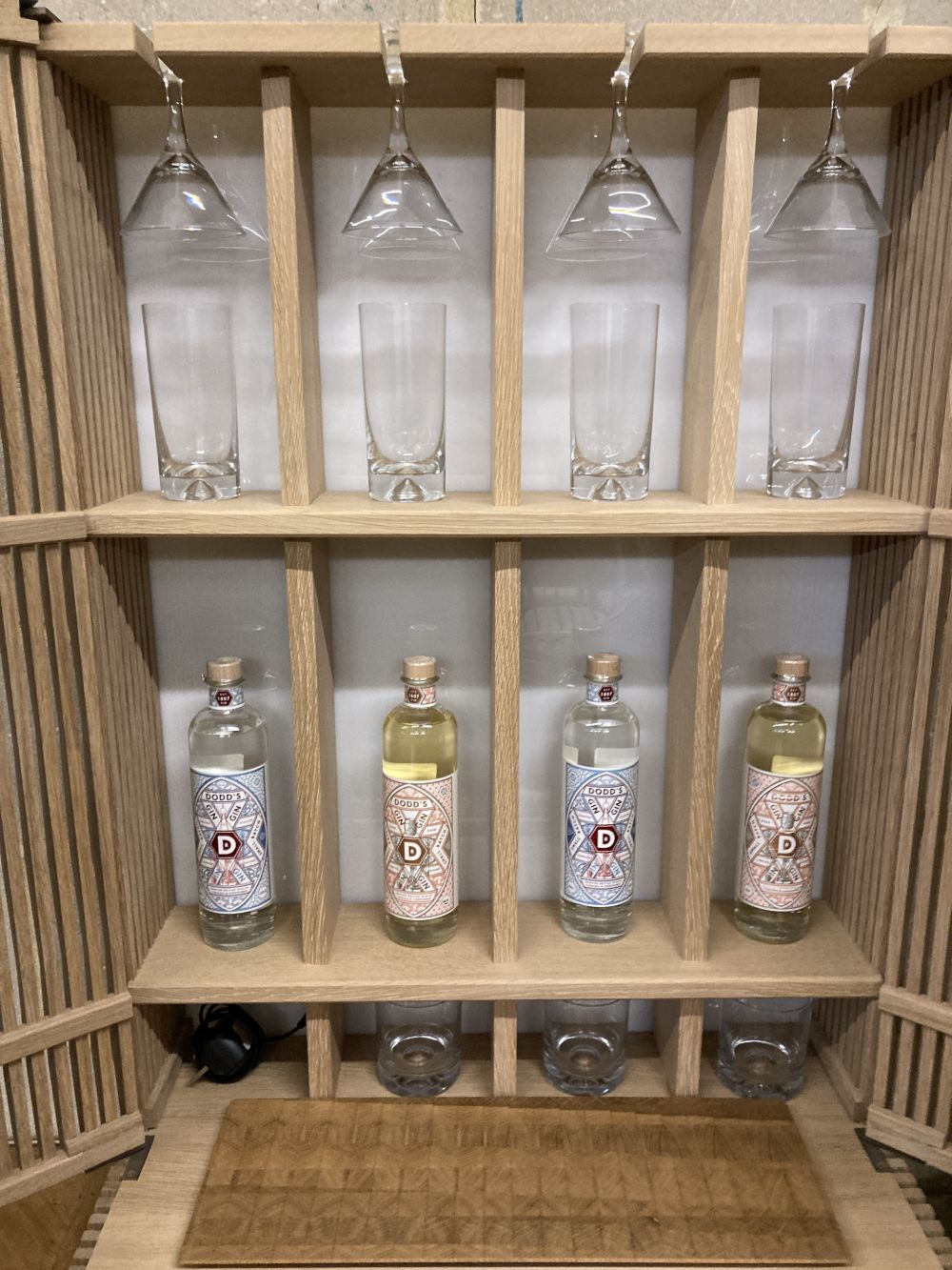 A Christopher Coane design British oak spirits cabinet, supplied with British spirits glassware and stainless steel accessories, width